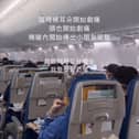 Passengers hold oxygen masks to their faces after their plane dropped 26,900ft.