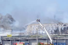 Fire crews on an aerial platform tackling the blaze on Wednesday, June 26.