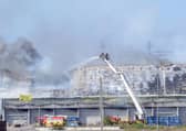 Fire crews on an aerial platform tackling the blaze on Wednesday, June 26.