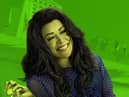 Tatiana Maslany as She-Hulk. She has green skin and big hair; the background behind her has a lime green wash over it (Credit: Marvel/Disney+)