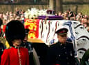 Soldiers accompany a gun carriage holding the coffin bearing the Queen Mother April 5, 2002.