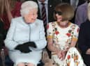 LONDON, ENGLAND - FEBRUARY 20:  Queen Elizabeth II sits next to Anna Wintour as they view Richard Quinn’s runway show before presenting him with the inaugural Queen Elizabeth II Award for British Design as she visits London Fashion Week’s BFC Show Space on February 20, 2018 in London, United Kingdom. (Photo by Yui Mok - Pool/Getty Images)
