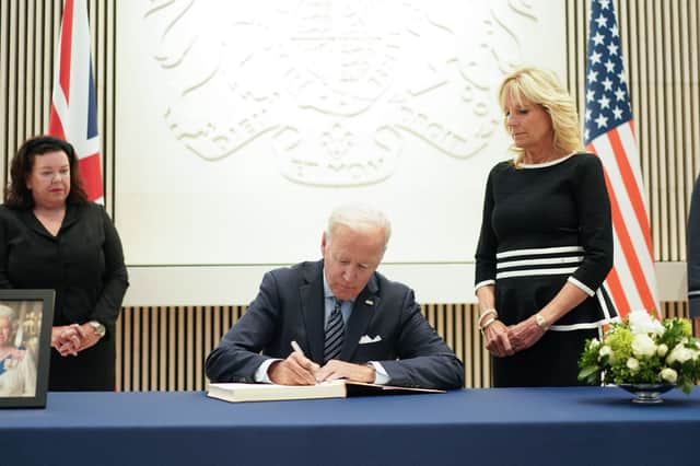 US President Joe Biden signs the condolence book at the British Embassy in Washington to pay his respects following the death of Britain’s Queen Elizabeth II. (Photo by MANDEL NGAN/AFP via Getty Images)