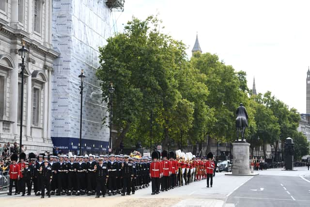 The Queen's funeral cortege borne on the State Gun Carriage of the Royal Navy travels along Whitehall following the State Funeral of Queen Elizabeth II at Westminster Abbey