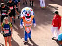 Members of the public finish during the 2021 Virgin Money London Marathon