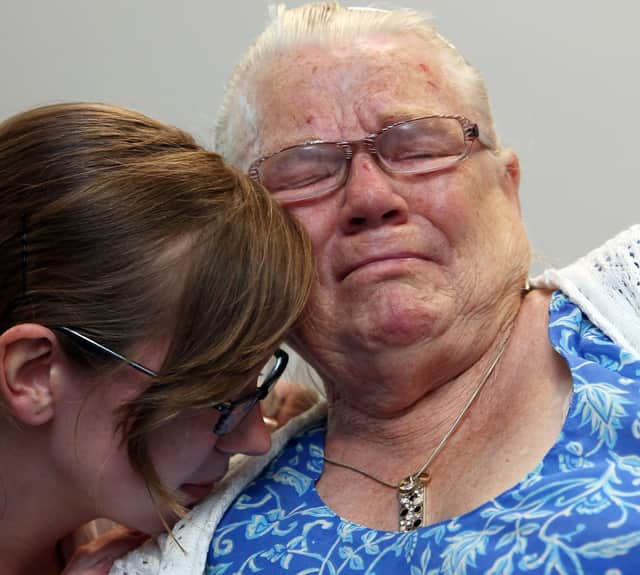Winnie Johnson, the mother of Saddleworth Moor murder victim Twelve-year-old Keith Bennett, is consoled by her friend Elizabeth Bond, as she watches TV coverage of Greater Manchester Police announcing that the search for his body is now entering a dormant phase on July 1, 2009.
