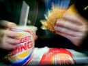  A man eats his lunch at a Burger King restaurant.