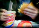  A man eats his lunch at a Burger King restaurant.