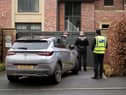Police officers standing outside Mason Greenwood’s house in February 2022.