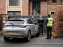 Police officers standing outside Mason Greenwood’s house in February 2022.
