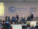 Prime Minister Rishi Sunak is seen running off the stage at an event at COP27 in Egypt.