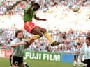 Forward Francois Omam-Biyick from Cameroon scores with a header as Argentinian defenders Nestor Lorenzo (L) and Juan Simon look on during the opening match of Italia 90  (STAFF/AFP via Getty Images)