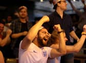 Football fans celebrate while watching the live broadcast of the final of the 2020 UEFA European Championships between England and Italy in the Oxford Arms pub in Camden on July 11, 2021 in London.