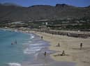 Tourists enjoy the beach in Phalasarna, northwest of the Greek mediterranean island of Crete