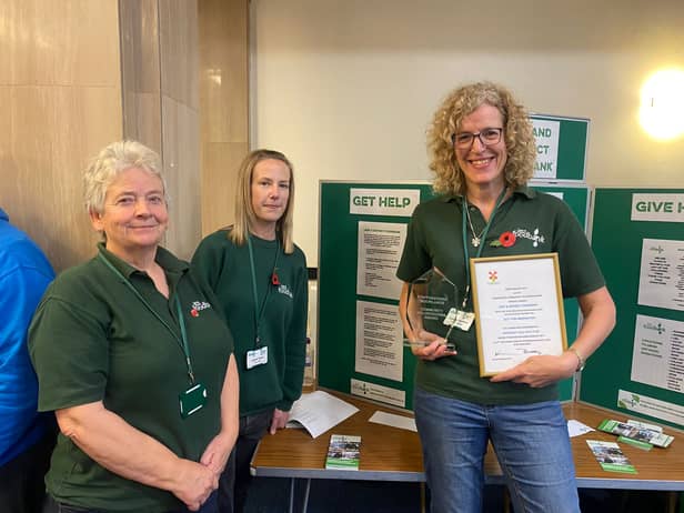 Lindsey Stockton (far right, holding framed document) with food bank colleagues