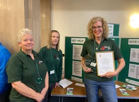 Lindsey Stockton (far right, holding framed document) with food bank colleagues