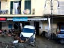 A man looks out from the balcony of his home in Casamicciola on November 27, 2022, following heavy rains that caused a landslide on the island of Ischia, southern Italy. - Italian rescuers were searching for a dozen missing people on the southern island of Ischia after a landslide killed at least one person, as the government scheduled an emergency meeting. A wave of mud and debris swept through the small town of Casamicciola Terme early Saturday morning, engulfing at least one house and sweeping cars down to the sea, local media and emergency services said. (Photo by Eliano IMPERATO / AFP) (Photo by ELIANO IMPERATO/AFP via Getty Images)