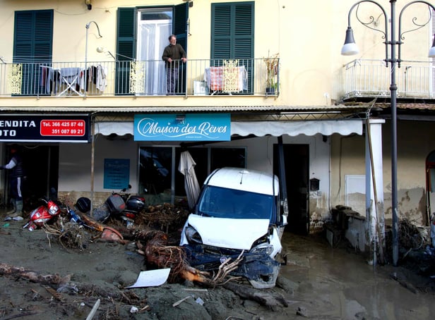 <p>A man looks out from the balcony of his home in Casamicciola on November 27, 2022, following heavy rains that caused a landslide on the island of Ischia, southern Italy. - Italian rescuers were searching for a dozen missing people on the southern island of Ischia after a landslide killed at least one person, as the government scheduled an emergency meeting. A wave of mud and debris swept through the small town of Casamicciola Terme early Saturday morning, engulfing at least one house and sweeping cars down to the sea, local media and emergency services said. (Photo by Eliano IMPERATO / AFP) (Photo by ELIANO IMPERATO/AFP via Getty Images)</p>