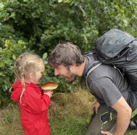 Jim Parums and his daugher foraging a mushroom - the family save £100 a week by foraging for all their meals. 