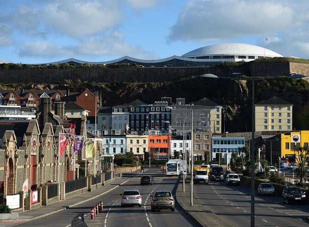 <p>Cars travel by the seafront in St Helier, on the British island of Jersey</p>