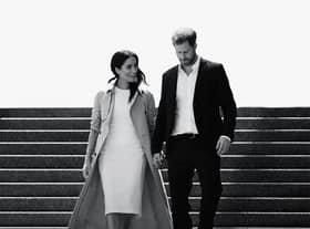A black and white image of Meghan Markle and Prince Harry walking down a flight of stairs together, hand in hand and smiling (Credit: Netflix) 