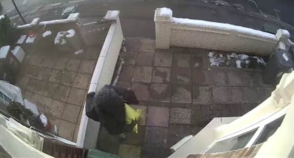 CCT shows the man scurrying into the yard before taking the parcel from underneath the bin.