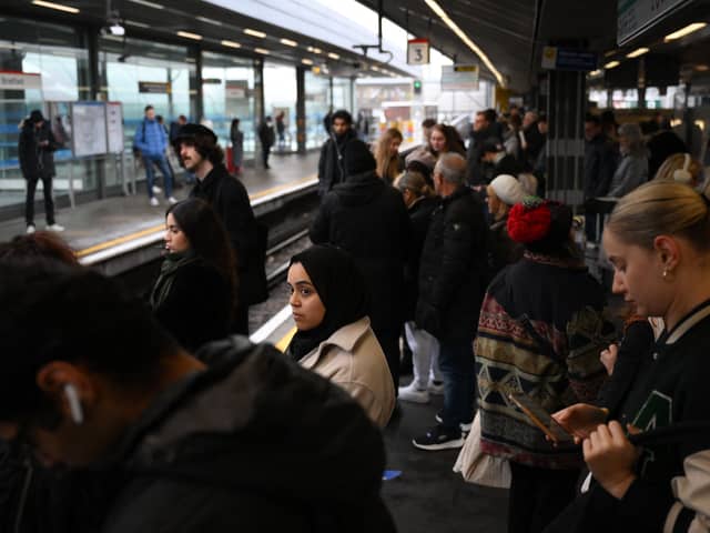 Commuters wait for an extremely delayed Central Line train at Stratford station in London on December 13  as rail strikes began a wave of festive walkouts in the country.