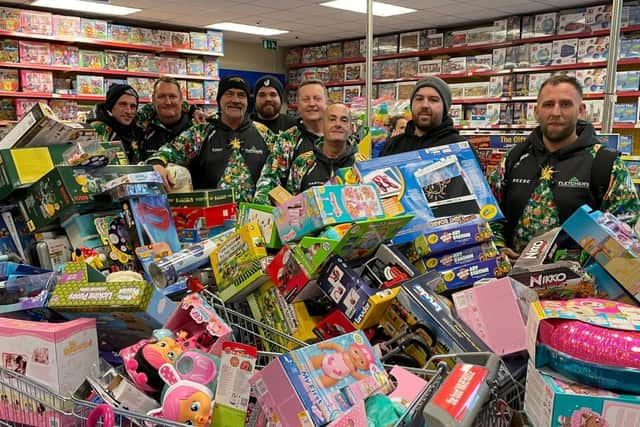 Reese, far right, and his team with some of hundreds of toys they bough from Smyth's Toy Shop