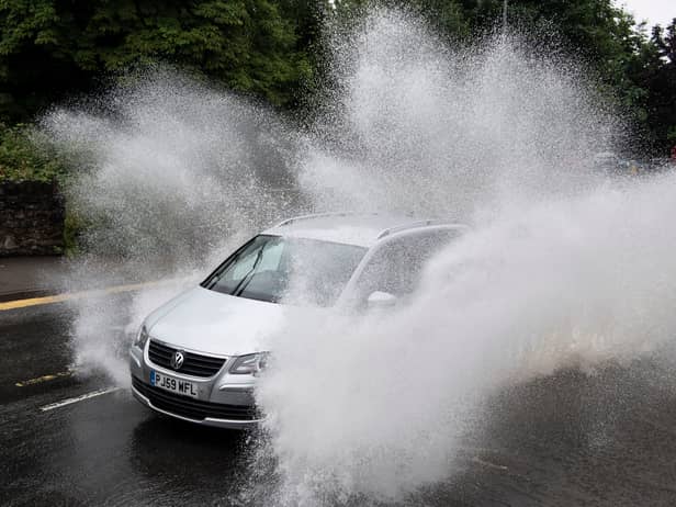 A car drives through floodwater (Photo by Matthew Horwood/Getty Images)
