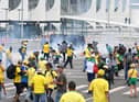 Supporters of Brazilian former President Jair Bolsonaro clash with the police during a demonstration outside the Planalto Palace in Brasilia on January 8, 2023. - Brazilian police used tear gas Sunday to repel hundreds of supporters of far-right ex-president Jair Bolsonaro after they stormed onto Congress grounds one week after President Luis Inacio Lula da Silva's inauguration, an AFP photographer witnessed. (Photo by EVARISTO SA / AFP) (Photo by EVARISTO SA/AFP via Getty Images)