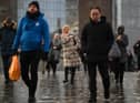 Commuters on their way to work cross London Bridge in central London.