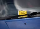 A Penalty Charge Notice (PCN) or parking ticket is pictured attached to the windscreen of a van in south London. Credit: DANIEL LEAL/AFP via Getty Images