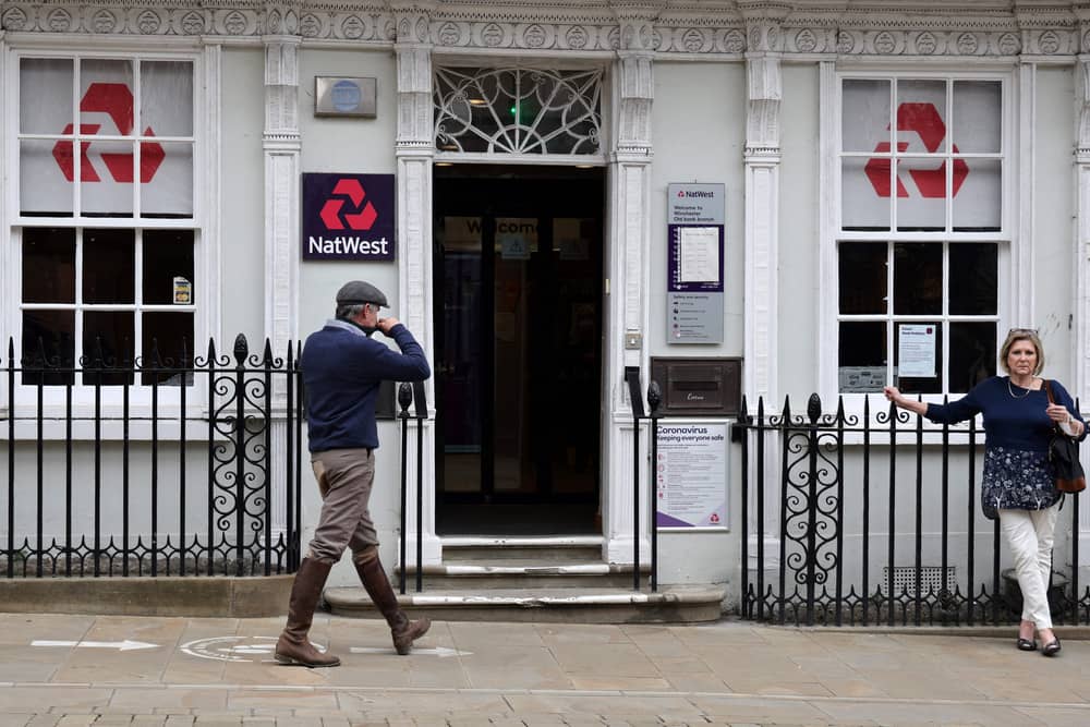 Customers use a NatWest bank on the High Street in Winchester, south west England on March 31, 2021. (Photo by ADRIAN DENNIS / AFP) (Photo by ADRIAN DENNIS/AFP via Getty Images)
