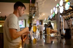 A customer buys a drink at a Wetherspoons pub in Clapham, London.