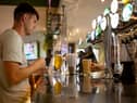 A customer buys a drink at a Wetherspoons pub in Clapham, London.