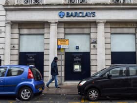 A man walks past a Barclays bank, in the Channel island's port capital Saint Helier, on December 11, 2022. (Photo by Sebastien SALOM-GOMIS / AFP) (Photo by SEBASTIEN SALOM-GOMIS/AFP via Getty Images)