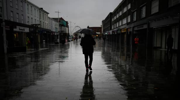 Dismal weather heralds the arrival of the UK Chancellor’s Autumn Statement as people shop in the centre of Bolton.