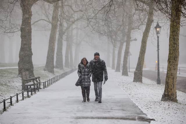 A couple walk through St James’s Park during a snow flurry on February 26, 2018 in London. Freezing weather conditions dubbed the “Beast from the East” brought snow and sub-zero temperatures to the UK. (Photo by Jack Taylor/Getty Images)
