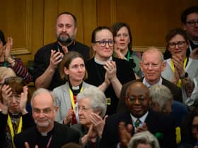 : Members of the General Synod react after blessings for same-sex couples was approved in a vote by the General Synod at The Church House.