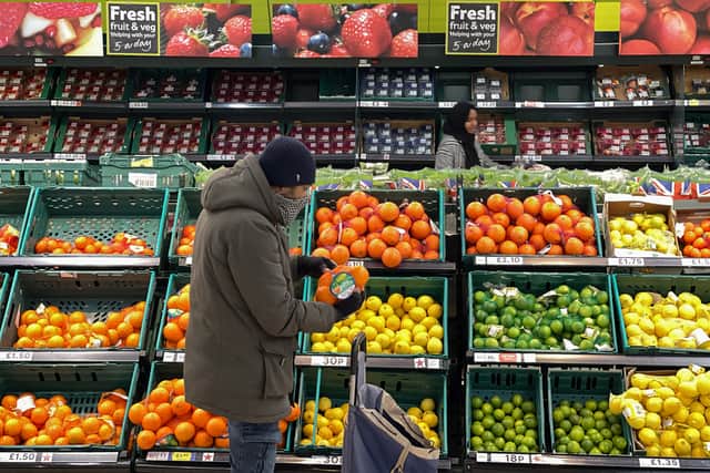 A customer shops for food items inside a Tesco supermarket store in east London on January 10, 2022. (Photo by DANIEL LEAL/AFP via Getty Images)