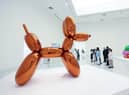 A woman accidentally destroyed a Jeff Koons glass sculpture believing it to be a balloon dog.
