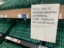 Empty shelves are seen in the fruit and vegetable aisles of a Tesco supermarket on February 22 in Burgess Hill.