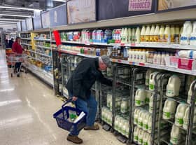 A customer shops for milk inside a Sainsbury's supermarket in east London on February 20, 2023.