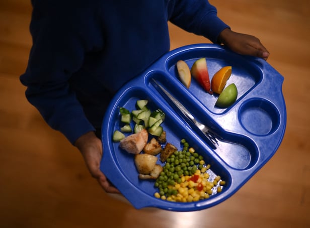 <p>A child carries a tray with food during lunch-break at St Mary’s RC Primary School, in Battersea, south London.</p>