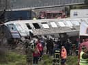 Police and emergency crews search wreckage after a train accident in the Tempi Valley near Larissa, Greece, March 1, 2023. - At least 32 people were killed and another 85 injured after a collision between two trains caused a derailment near the Greek city of Larissa late at night on February 28, 2023, authorities said. A fire services spokesman confirmed that three carriages skipped the tracks just before midnight after the trains -- one for freight and the other carrying 350 passengers - collided about halfway along the route between Athens and Thessaloniki. (Photo by Sakis MITROLIDIS / AFP) (Photo by SAKIS MITROLIDIS/AFP via Getty Images)