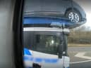 Footage shows the driver using his elbow to control the car transporter (Photo: Highways England) 