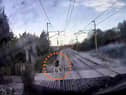 The video shows a man just inches from being hit by the speeding train.