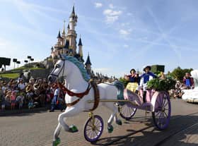 Crowds watch as Snow White and her prince ride past on a carriage during the Main Street Parade at Disneyland Paris.