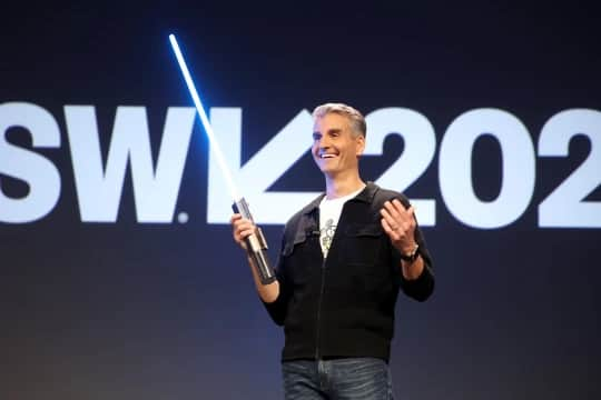 Josh D’Amaro, Disney’s parks and experiences chairman, with a ‘real’ Star Wars lightsaber