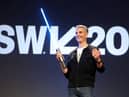 Josh D’Amaro, Disney’s parks and experiences chairman, with a ‘real’ Star Wars lightsaber